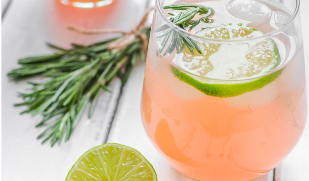 glass-of-fresh-juice-with-lime-rosemary-and-knife-on-wooden-picture-id674347648.jpg